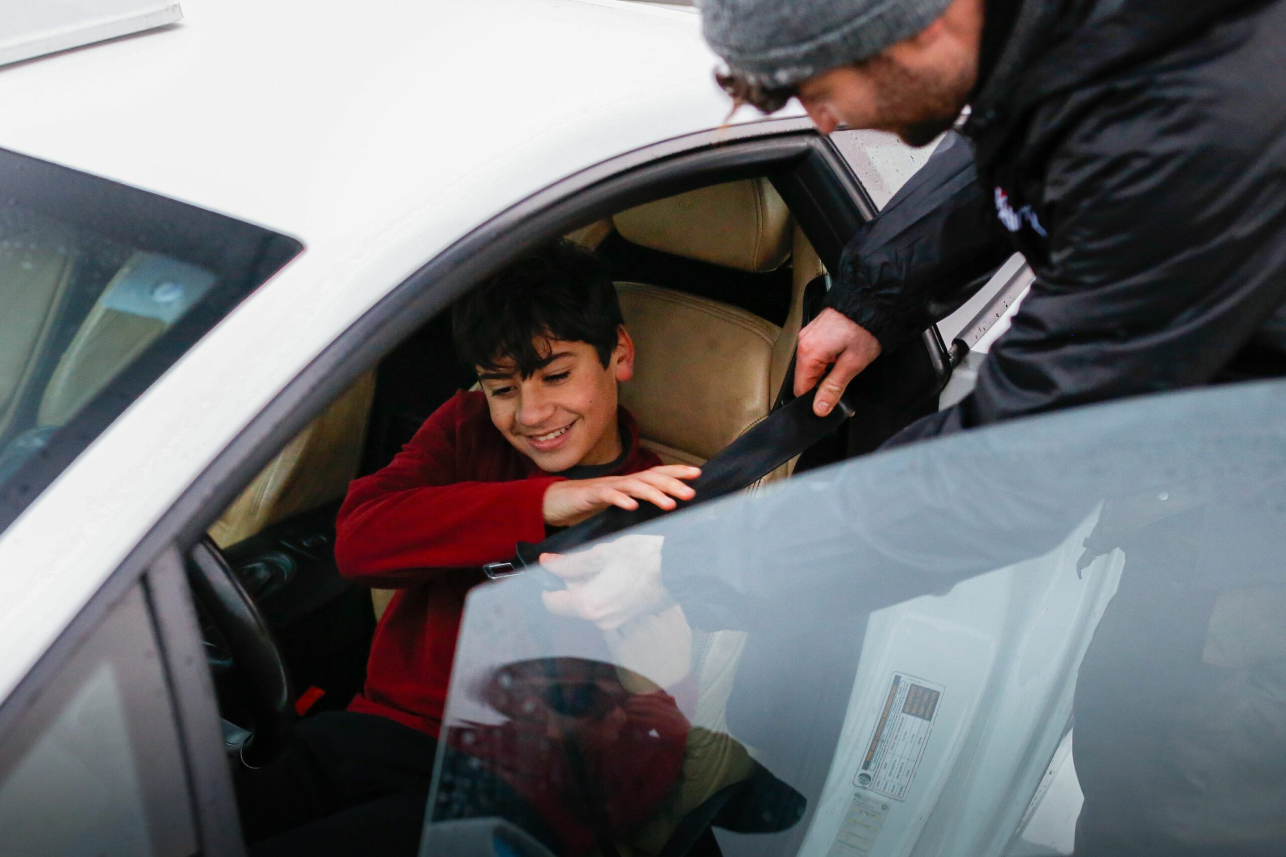 young driver sat in a car