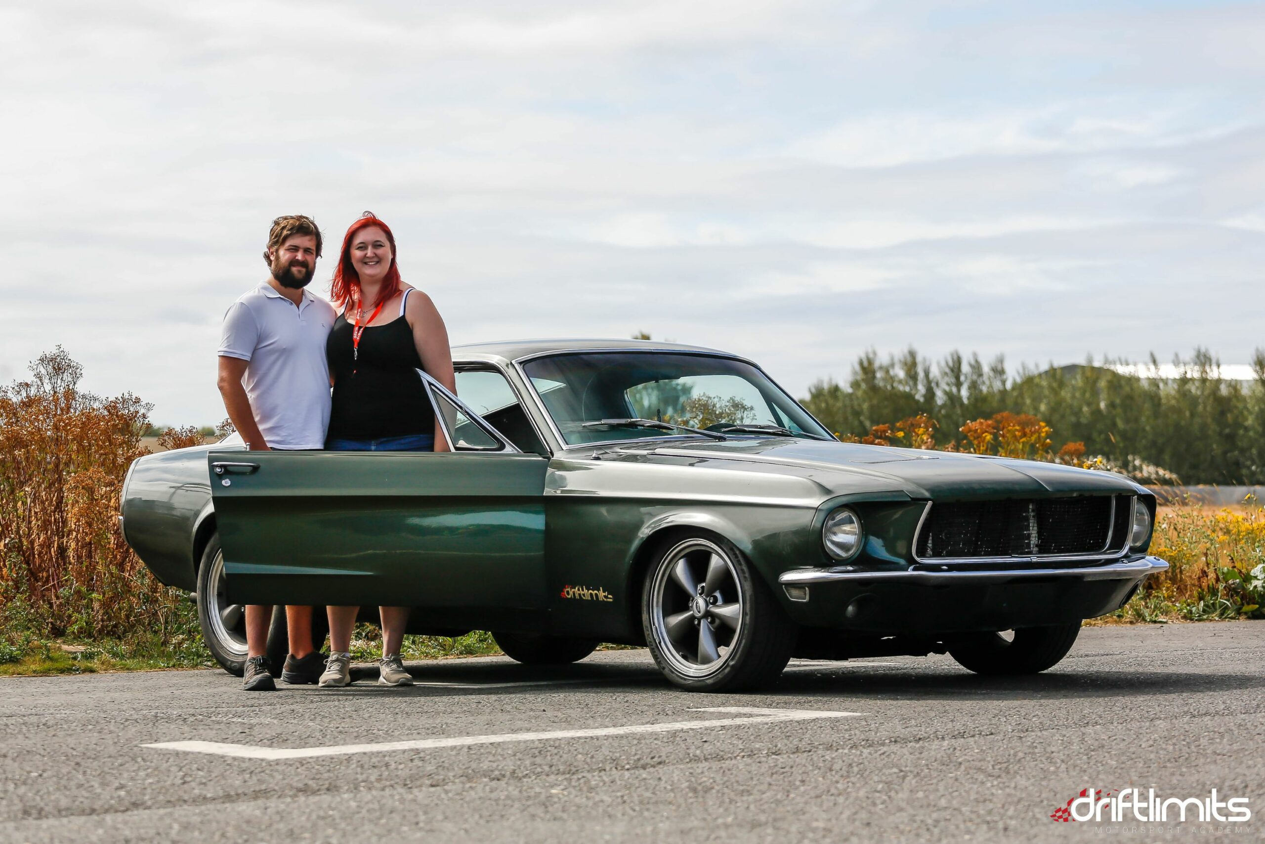 38 couple stood next to a mustang