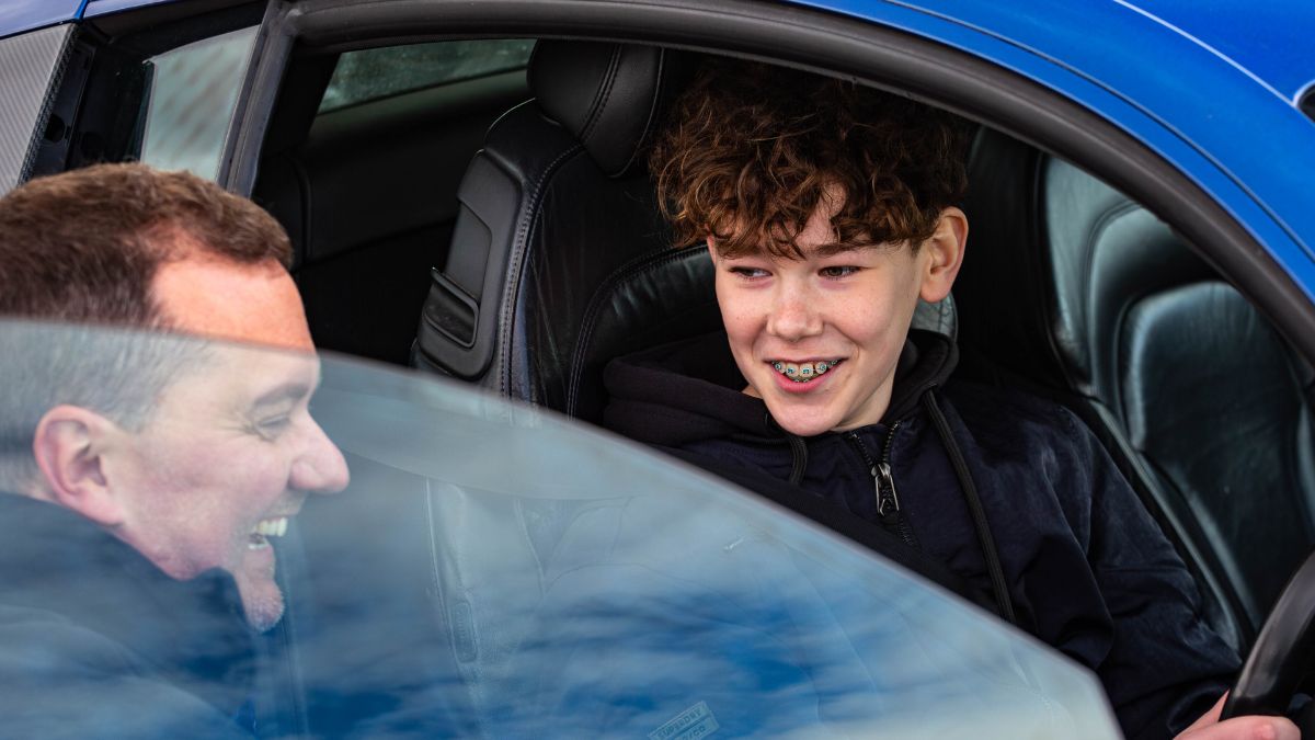 Untitled design kid sat in a car with an instructor